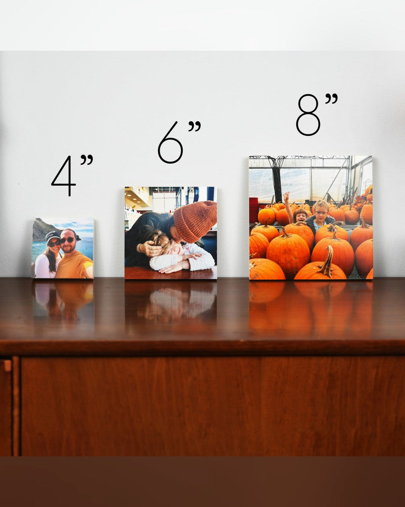 Wood photo blocks in three sizes, four inch, six inch and eight inch, standing side by side on a walnut dresser