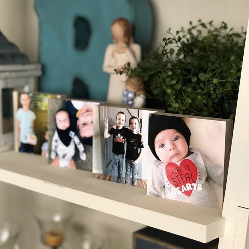 A customer photo wall of Shiner wood blocks