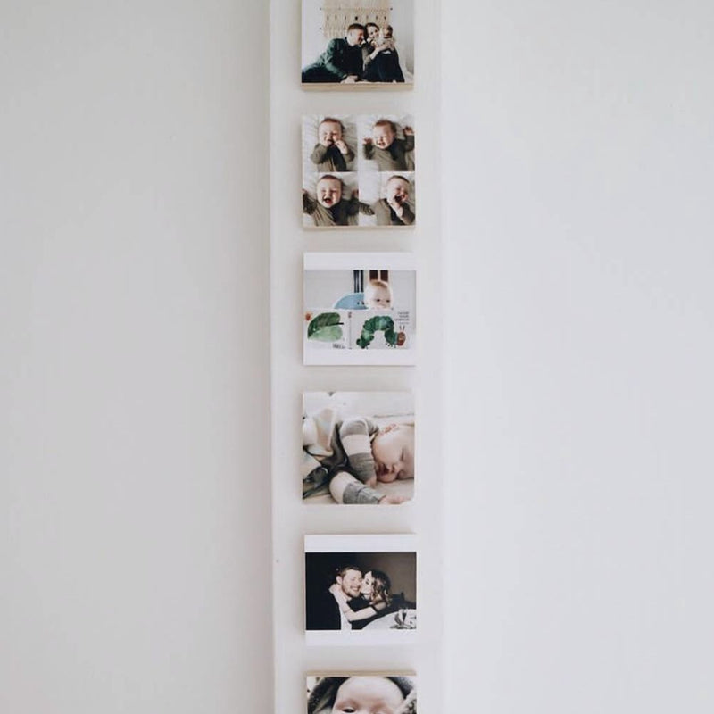 A customer photo wall of Shiner wood blocks